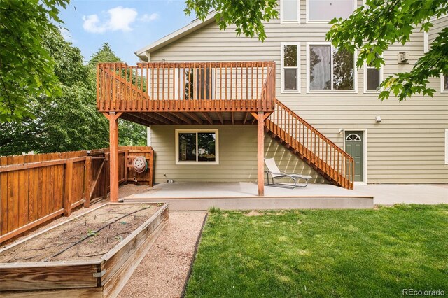 1477 Serene Dr, Erie, CO 80516 - back of property with a patio, a deck, a vegetable garden, and stairway