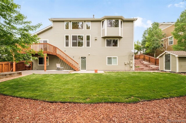 1477 Serene Dr, Erie, CO 80516 - rear view of property with stairway, a patio, and a wooden deck