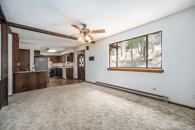 unfurnished living room featuring carpet floors, a baseboard radiator, baseboards, and a ceiling fan