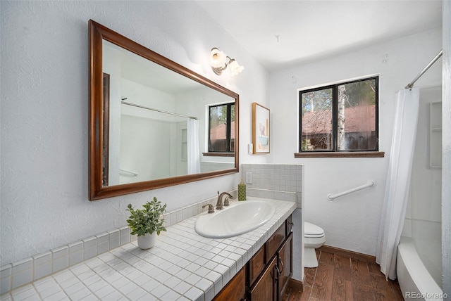full bathroom featuring vanity, baseboards, toilet, and wood finished floors