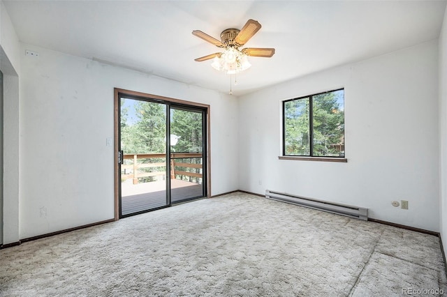 carpeted spare room with baseboards, a baseboard radiator, a ceiling fan, and a healthy amount of sunlight