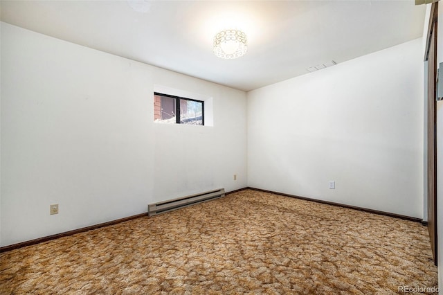 empty room featuring carpet flooring, baseboards, a baseboard heating unit, and visible vents