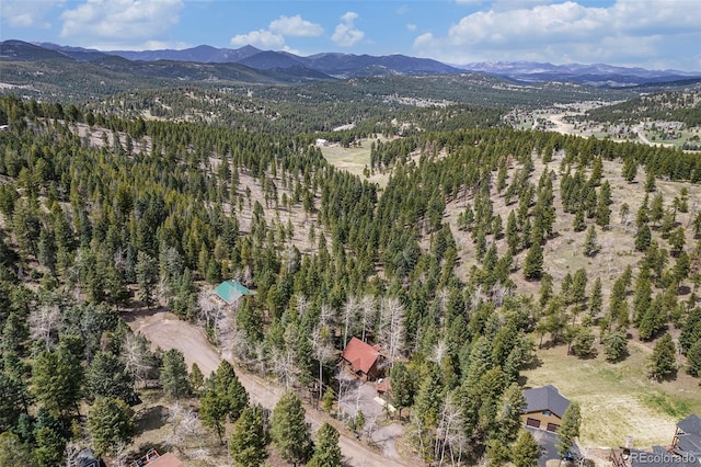 drone / aerial view featuring a view of trees and a mountain view