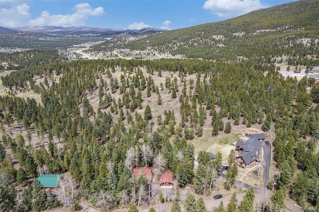 aerial view with a mountain view and a forest view