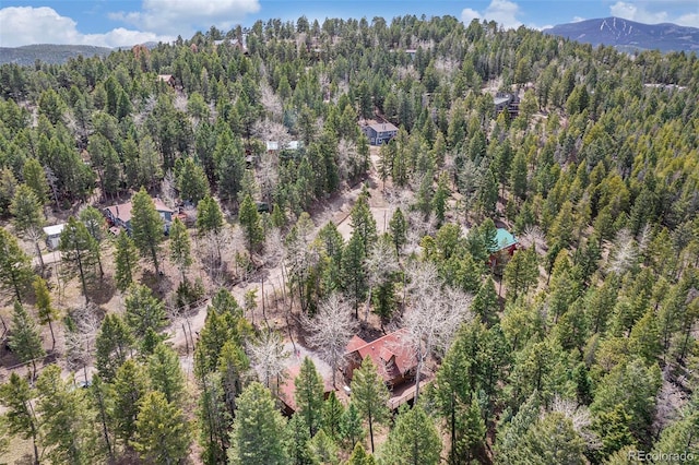 birds eye view of property with a view of trees