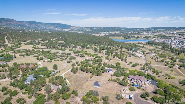 drone / aerial view with a water and mountain view