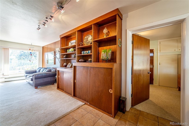 interior space featuring baseboard heating and light tile patterned floors