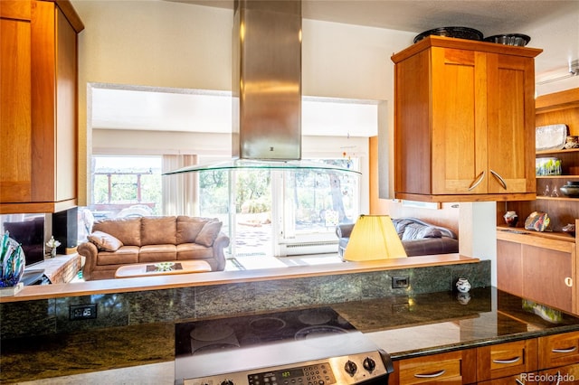 kitchen featuring dark stone counters, island exhaust hood, and stainless steel range