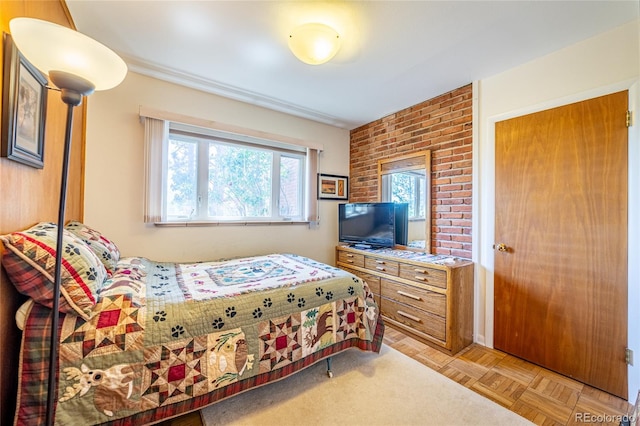 bedroom with light parquet flooring and multiple windows