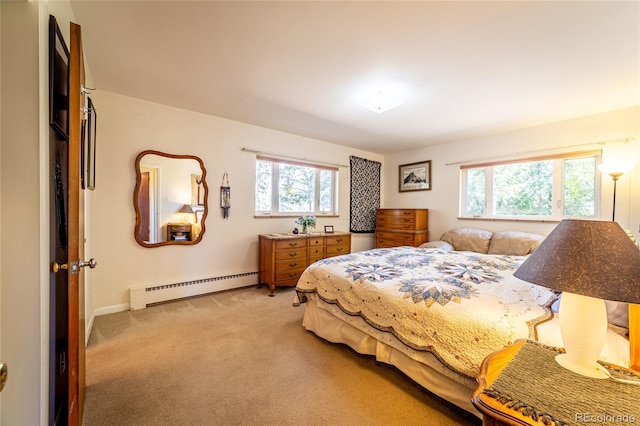 carpeted bedroom featuring multiple windows and baseboard heating