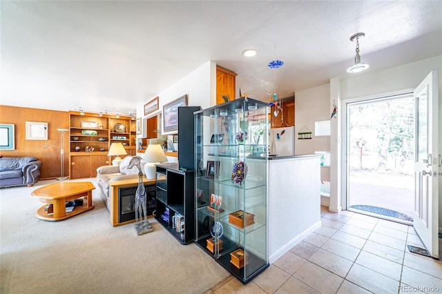 kitchen with a textured ceiling, light tile patterned floors, and white fridge