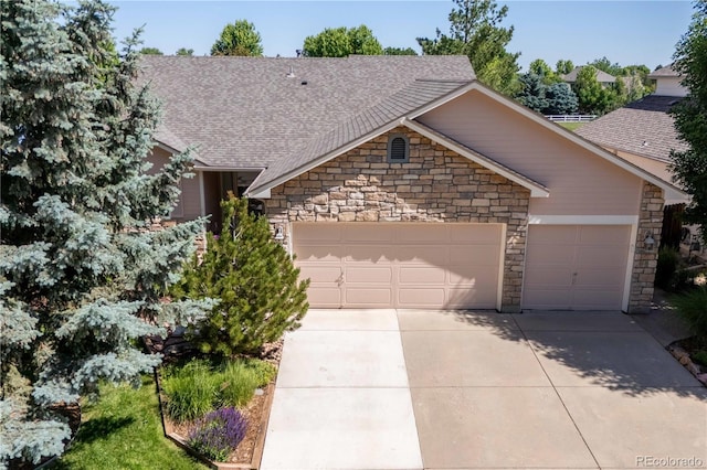 1376 Banner Cir, Erie, CO 80516 - single story home featuring a garage, stone siding, a shingled roof, and driveway