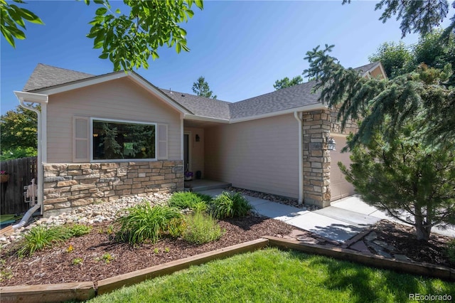 1376 Banner Cir, Erie, CO 80516 - single story home with stone siding, a shingled roof, and a garage