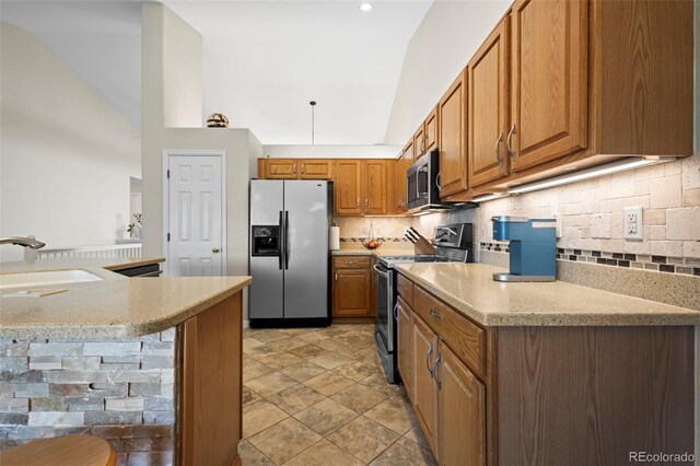 1376 Banner Cir, Erie, CO 80516 - kitchen with stainless steel appliances, brown cabinets, backsplash, light stone counters, and high vaulted ceiling