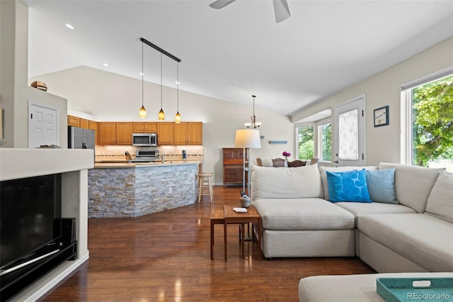 1376 Banner Cir, Erie, CO 80516 - living room with lofted ceiling, plenty of natural light, dark wood-style flooring, ceiling fan, and recessed lighting