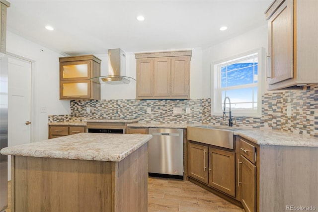 kitchen featuring a kitchen island, dishwasher, sink, light stone countertops, and wall chimney range hood