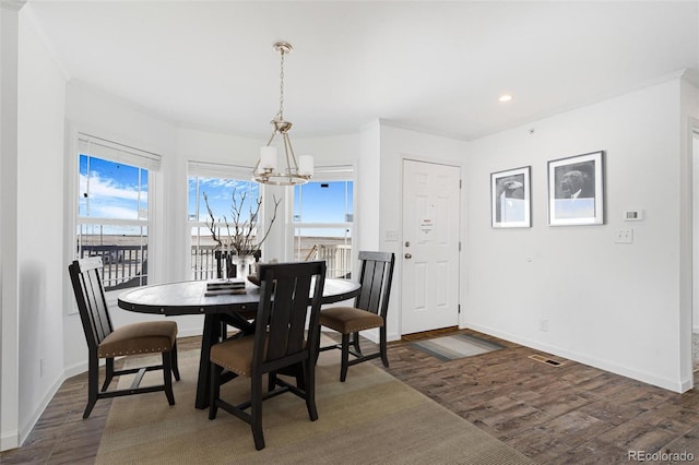 dining area featuring dark hardwood / wood-style floors and a notable chandelier