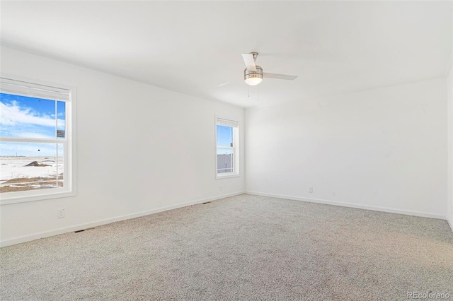 spare room with carpet floors and ceiling fan