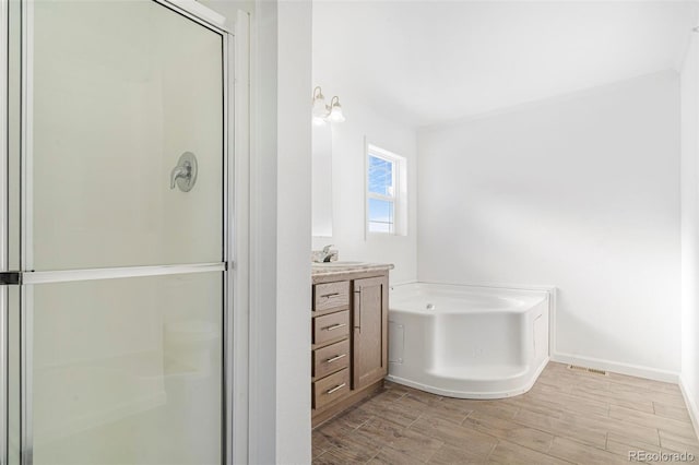 bathroom with vanity and separate shower and tub