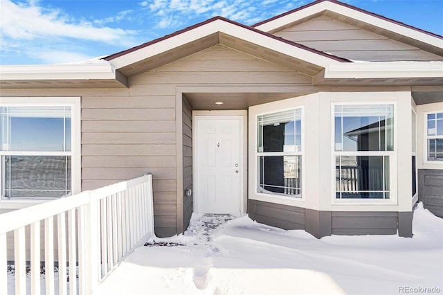 view of snow covered property entrance