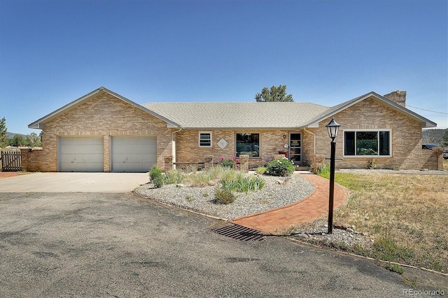510 Crossman Ave, Buena Vista, CO 81211 - single story home featuring brick siding, a garage, driveway, and a chimney