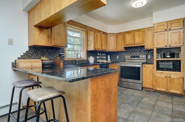 510 Crossman Ave, Buena Vista, CO 81211 - kitchen featuring black appliances, a peninsula, tasteful backsplash, a breakfast bar area, and brown cabinetry