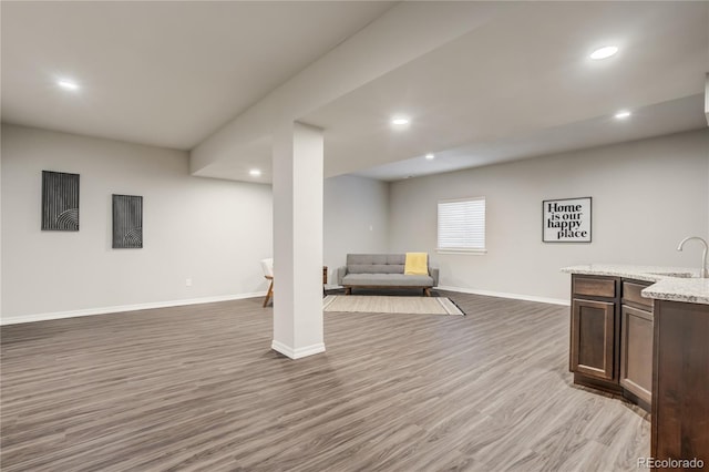 interior space with recessed lighting, baseboards, and wood finished floors