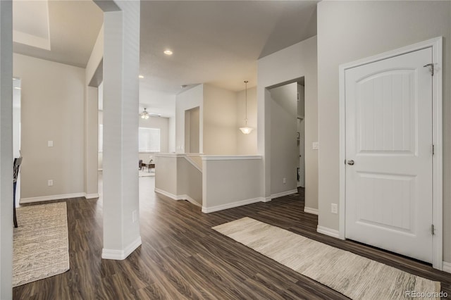 empty room featuring a ceiling fan, baseboards, dark wood-type flooring, and recessed lighting