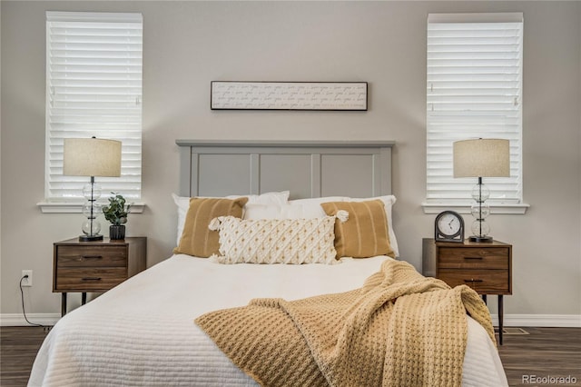 bedroom featuring baseboards and dark wood finished floors