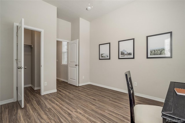 office space with baseboards and wood finished floors