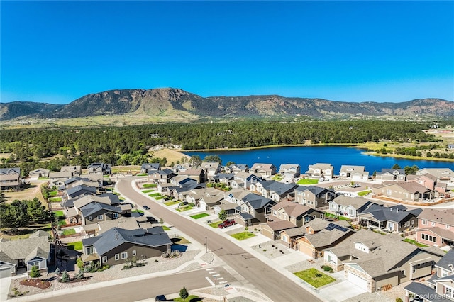 drone / aerial view with a residential view and a water and mountain view