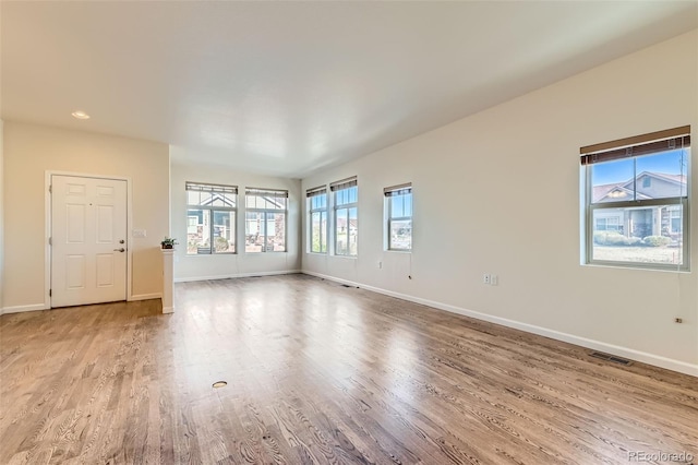 12625 Madison Way, Thornton, CO 80241 - unfurnished living room featuring wood finished floors, baseboards, and visible vents