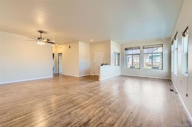 12625 Madison Way, Thornton, CO 80241 - unfurnished living room with light wood-style flooring, baseboards, and ceiling fan