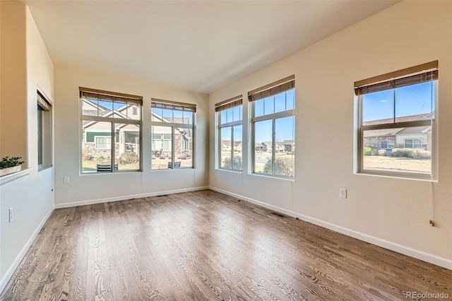 12625 Madison Way, Thornton, CO 80241 - empty room featuring baseboards and wood finished floors