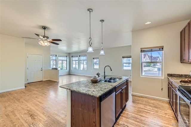 12625 Madison Way, Thornton, CO 80241 - kitchen with baseboards, a sink, a ceiling fan, light wood finished floors, and stainless steel appliances