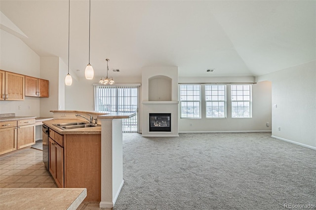 2552 W 82nd Ln Unit C, Westminster, CO 80031 - kitchen with lofted ceiling, dishwashing machine, open floor plan, a kitchen island with sink, and light colored carpet