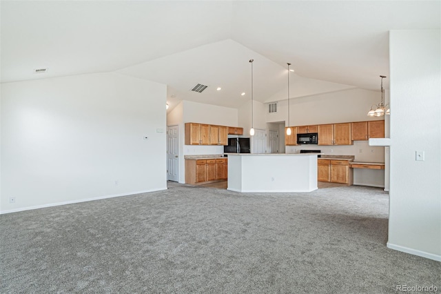 2552 W 82nd Ln Unit C, Westminster, CO 80031 - kitchen featuring black appliances, open floor plan, light carpet, decorative light fixtures, and brown cabinets