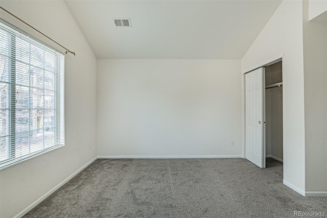 2552 W 82nd Ln Unit C, Westminster, CO 80031 - unfurnished bedroom with lofted ceiling, multiple windows, carpet floors, and a closet