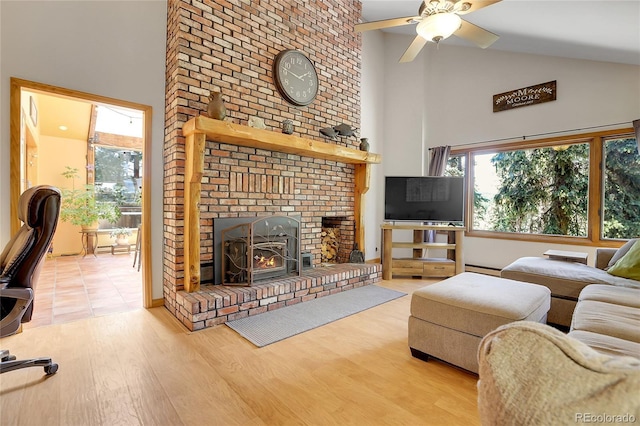 7753 Red Fox Dr, Evergreen, CO 80439 - living area featuring high vaulted ceiling, a ceiling fan, wood finished floors, and a brick fireplace