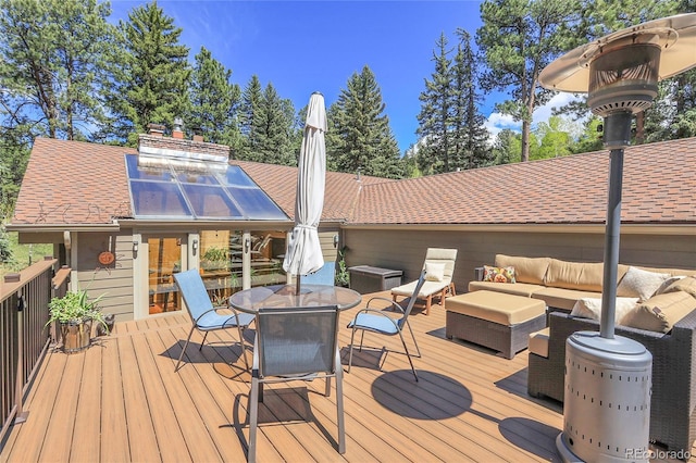 7753 Red Fox Dr, Evergreen, CO 80439 - wooden deck featuring an outdoor living space and outdoor dining space
