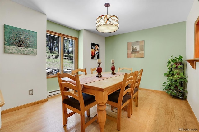 7753 Red Fox Dr, Evergreen, CO 80439 - dining area featuring light wood finished floors, a baseboard radiator, and baseboards