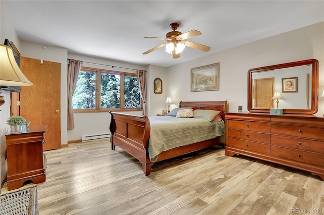 7753 Red Fox Dr, Evergreen, CO 80439 - bedroom with baseboard heating, light wood-style flooring, a ceiling fan, and baseboards