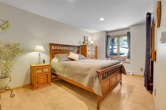 7753 Red Fox Dr, Evergreen, CO 80439 - bedroom featuring baseboard heating, baseboards, light wood finished floors, and recessed lighting