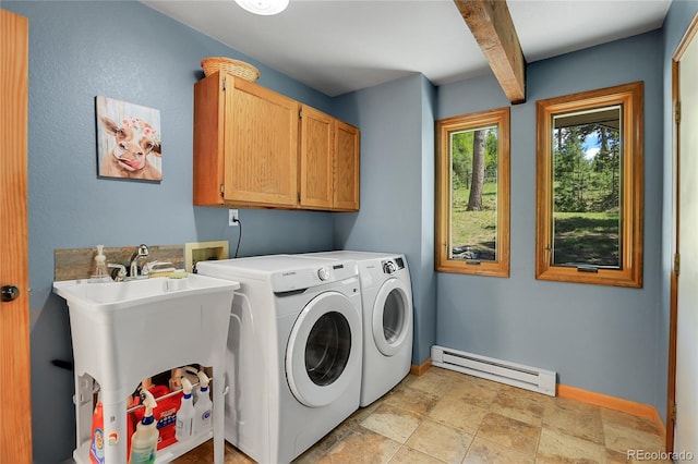 7753 Red Fox Dr, Evergreen, CO 80439 - washroom with baseboard heating, cabinet space, separate washer and dryer, baseboards, and stone finish flooring