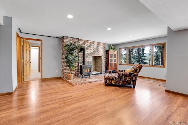 7753 Red Fox Dr, Evergreen, CO 80439 - living room with a wood stove, wood finished floors, baseboards, and recessed lighting