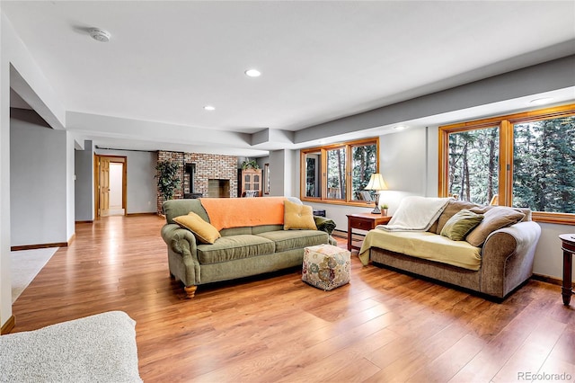 7753 Red Fox Dr, Evergreen, CO 80439 - living area featuring wood finished floors, recessed lighting, baseboards, a baseboard radiator, and a fireplace