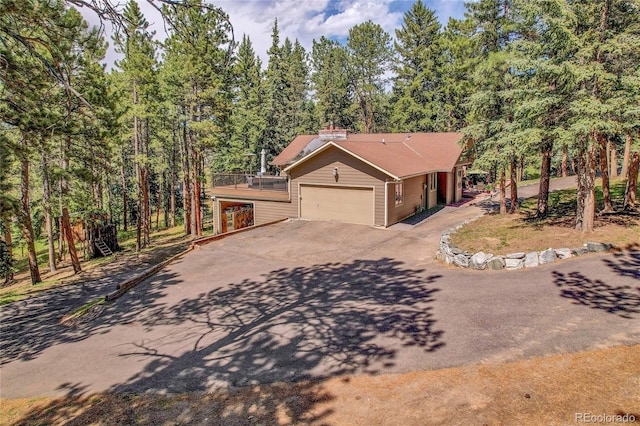 7753 Red Fox Dr, Evergreen, CO 80439 - view of front of home with concrete driveway and an attached garage