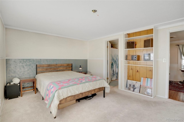 carpeted bedroom featuring crown molding