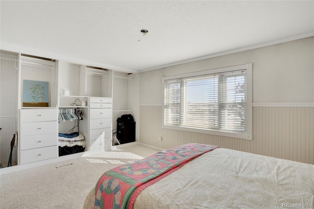 bedroom with ornamental molding and a textured ceiling