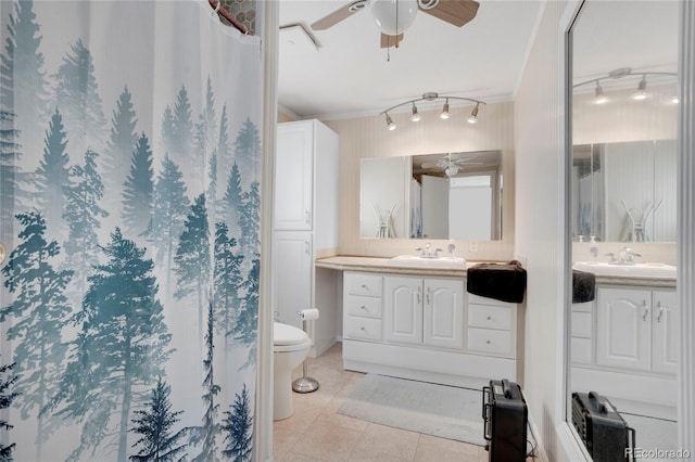 bathroom with tile patterned flooring, ornamental molding, vanity, ceiling fan, and toilet